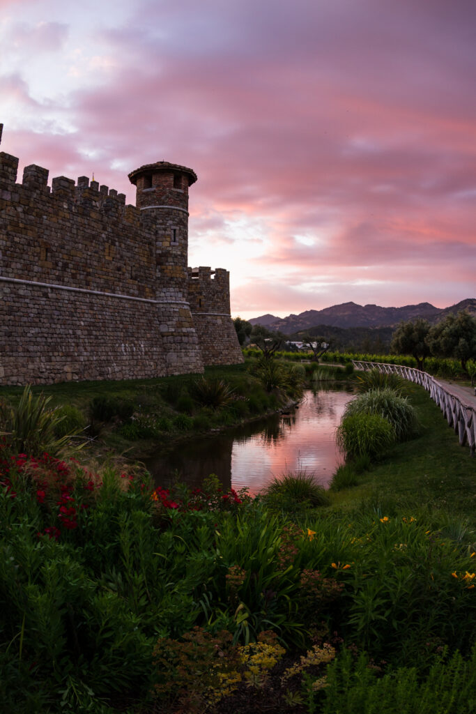 Castle in Napa Valley at sunset with a reflection on the mote